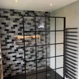 Black grid shower panel. Metro brick wall tiles and black shower inline tray
