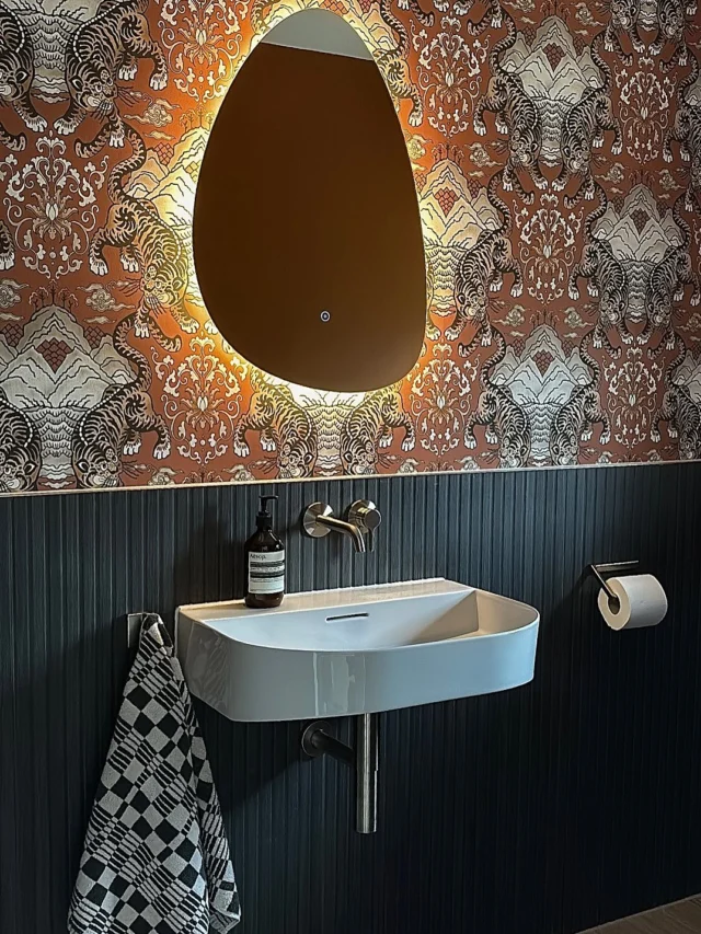 Bold meets Balanced 🐅✨

We had the pleasure of transforming this cloakroom into a true statement space (swipe to see the before). 

Burnt orange walls, tiger-print wallpaper and ebony tiled panelling add depth and drama, creating a striking yet balanced visual impact. 

The floating basin paired with brushed nickel brassware and a softly backlit LED mirror keeps the look refined and contemporary - proof that even compact spaces can leave a lasting impression.

Designed, supplied and installed by our in-house team, from concept through to completion.

#statementcloakroom #tigerwallpaper #cloakroomdesign #cloakroominstallation #cloakroominspo