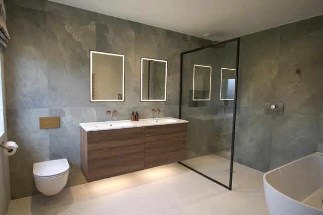 Textured & Tranquil ☁️ 

This master en suite was designed, supplied and installed by our team to create a calm, warm and sophisticated space.

Natural textures, a warm oak double vanity and soft lighting create a spa-like atmosphere, complemented by brushed bronze brassware, a walk-in shower and a corner bath for everyday relaxation.

The tiles are one of our favourite details - their subtle tonal variation adds depth while keeping the overall look soft and understated.

Swipe to see the before - we love this transformation!

#masterensuite #luxurybathroomdesign #luxurybathroominspo #bathroominstallation #bathroomtransformation