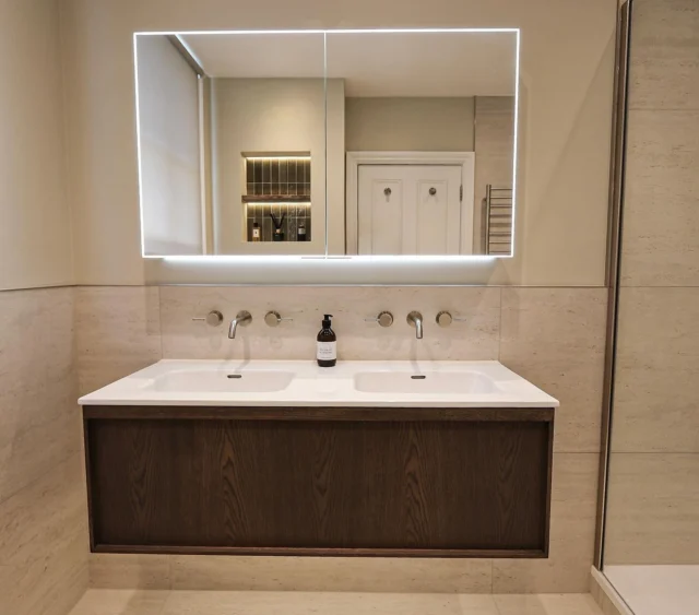 Neutral En Suite 🤎

This project was all about creating a calming, neutral aesthetic that feels both timeless and inviting. (Swipe to see the before.)

A floating vanity in a smoked oak finish, paired with brushed nickel brassware and an illuminated mirror cabinet, brings warmth, texture and functionality to the space. Large-format porcelain tiles enhance the sense of space while providing a clean, contemporary finish.

The spacious walk-in shower, complete with a heated towel rail, adds both comfort everyday practicality. 

Our favourite detail? The illuminated shower and wall niches. Lined with deep green glossy tiles, they introduce a pop of colour and texture while creating the perfect ambient glow.

Designed, supplied and installed by our in-house team.

Planning a bathroom renovation? Get in touch with our team today:

📞 01959 523 008
🌐 https://www.olympusbathrooms.co.uk/
 📧 info@olympusbathrooms.co.uk

#neutralbathroom #neutraldecor #ensuiteinspo #ensuitedesign #luxurybathroom