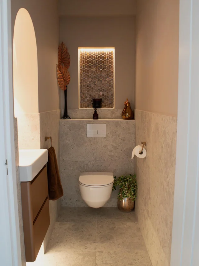 Copper Cloakroom ✨

This cloakroom was designed to feel calm, warm and inviting. (Swipe to see the before!) 

A palette of off-white pumice porcelain, brushed bronze and rich copper tones creates depth and warmth, while carefully layered lighting adds a soft, ambient atmosphere to the space.

Key design details:

✨ Arched alcove with a backlit circular mirror
✨Floating vanity in a copper finish with under-lighting
✨Brushed bronze wall-mounted tap and lever
✨Off-white pumice porcelain tiles
✨LED-lit niche finished with copper hexagonal mosaics

Designed, supplied and installed by our in-house team.

Ready to start your bathroom project? Get in touch with our team today:

📞 01959 523 008
🌐 https://www.olympusbathrooms.co.uk/
 📧 info@olympusbathrooms.co.uk

#cloakroom #cloakroomdesign #cloakroominspo #beforeandafter
