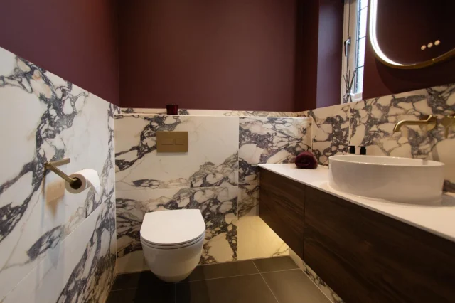A Cloakroom in Burgundy & Brass 🥀🪞

We love this finished space! Rich burgundy, warm oak tones and brushed brass details, brought together with beautifully veined Savoy Novo tiles. Soft lighting beneath the vanity and around the mirror adds the perfect glow.

Designed, supplied and installed by our in-house team.

Looking to renovate your bathroom? Get in touch with our team today:

📞 01959 523 008
🌐 https://www.olympusbathrooms.co.uk/
 📧 info@olympusbathrooms.co.uk 

#burgundycloakroom #cloakroomdesign #cloakroomrenovation #brassdecor #luxurybathroom
